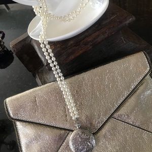 Long pearl necklace with large locket